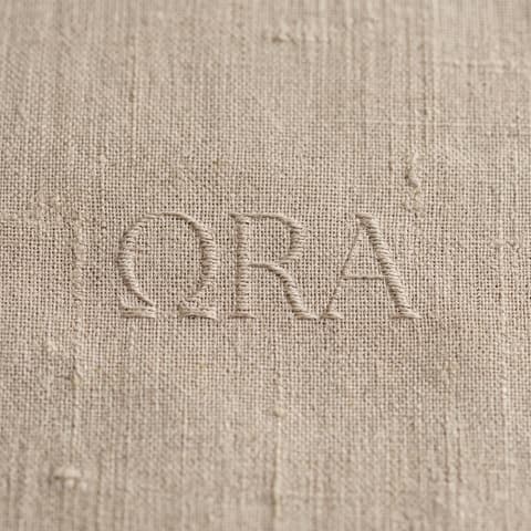The ora wordmark pressed into natural linen